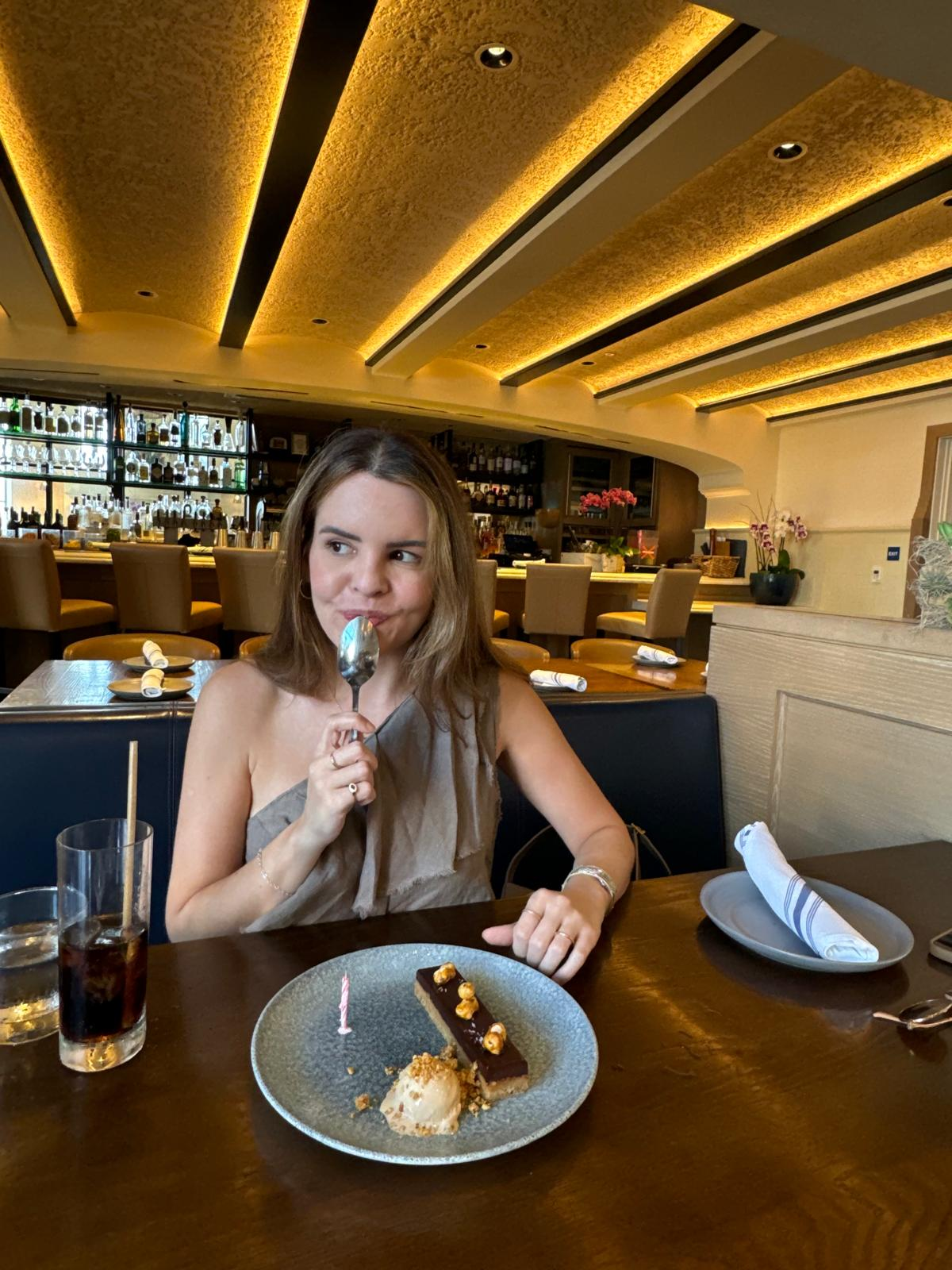 Karen with birthday dessert and candle