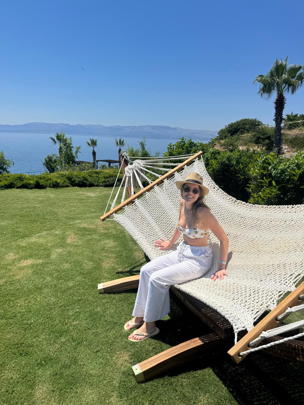 Karen relaxing on hammock with ocean view