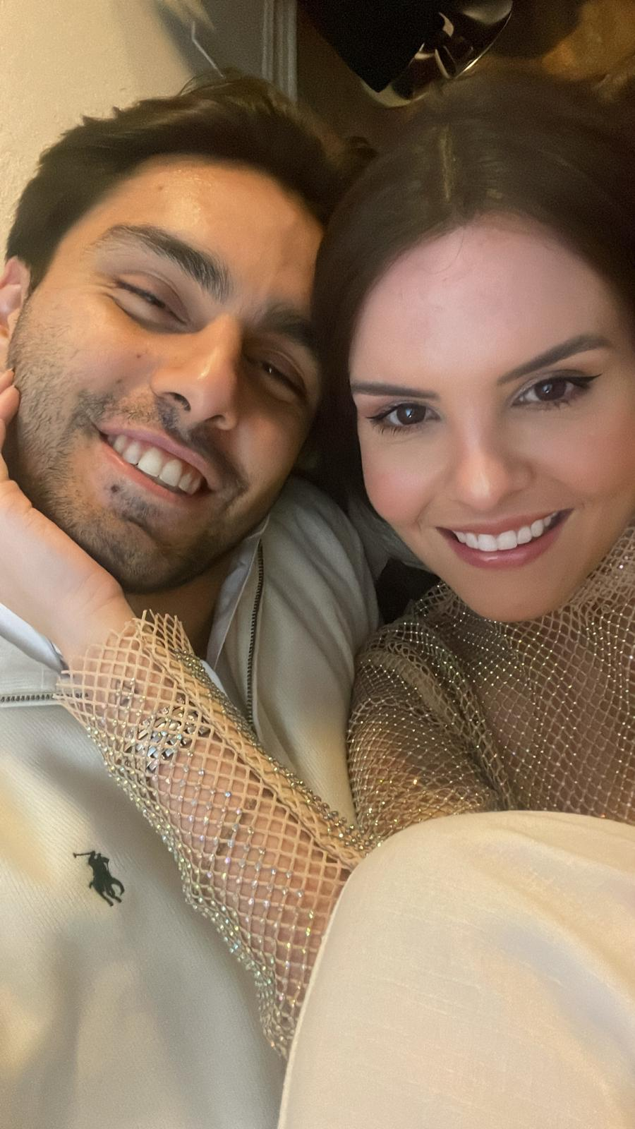 Couple in sparkly outfits celebrating New Year at home